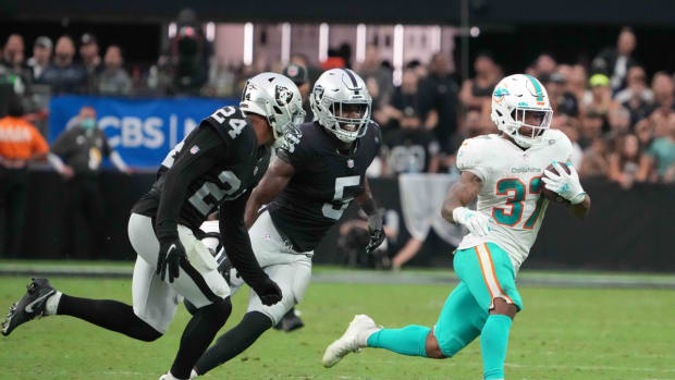 Sep 26, 2021; Paradise, Nevada, USA; Miami Dolphins running back Myles Gaskin (37) is pursued by Las Vegas Raiders defensive back Johnathan Abram (24) and linebacker Divine Deablo (5) in overtime at Allegiant Stadium.The Raiders defeated the Dolphins 31-28 in overtime. Mandatory Credit: Kirby Lee-USA TODAY Sports