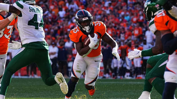 Sep 26, 2021; Denver, Colorado, USA; Denver Broncos running back Javonte Williams (33) carries the ball in the against the New York Jets at Empower Field at Mile High. Mandatory Credit: Ron Chenoy-USA TODAY Sports