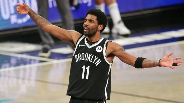 Brooklyn Nets point guard Kyrie Irving reacts during the third quarter against the Boston Celtics.