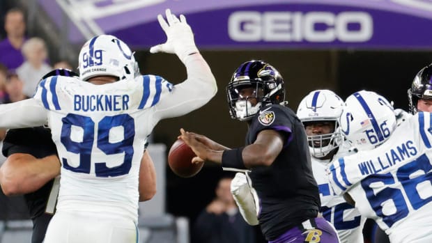 Oct 11, 2021; Baltimore, Maryland, USA; Baltimore Ravens quarterback Lamar Jackson (8) throws a touchdown pass to Baltimore Ravens wide receiver Marquise Brown (not pictured) under pressure from Indianapolis Colts defensive tackle DeForest Buckner (99) during the third quarter at M&T Bank Stadium. Mandatory Credit: Geoff Burke-USA TODAY Sports