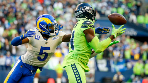 NFL: Los Angeles Rams at Seattle Seahawks Oct 7, 2021; Seattle, Washington, USA; Seattle Seahawks wide receiver DK Metcalf (14) catches a pass against Los Angeles Rams cornerback Jalen Ramsey (5) during the first quarter at Lumen Field. Mandatory Credit: Joe Nicholson-USA TODAY Sports