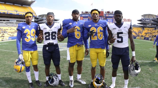 Sep 25, 2021; Pittsburgh, Pennsylvania, USA; Former Delaware state high school football players and current New Hampshire Wildcats running back Carlos Washington Jr. (26) and wide receiver Charles Briscoe III (5) along with Pittsburgh Panthers defensive back Myles Canton (39) and defensive lineman John Morgan III (6) and defensive back Judson Tallandier (26) pose for a photo following the game at Heinz Field. Mandatory Credit: Charles LeClaire-USA TODAY Sports