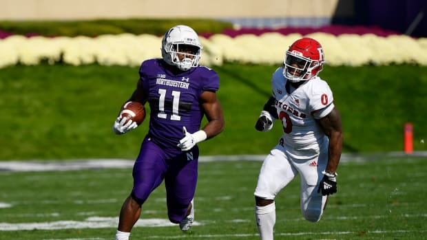 Oct 16, 2021; Evanston, Illinois, USA; Northwestern Wildcats running back Andrew Clair (11) runs with the football in the first half against Rutgers Scarlet Knights defensive back Christian Izien (0) at Ryan Field. Mandatory Credit: Quinn Harris-USA TODAY Sports