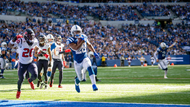 Oct 17, 2021; Indianapolis, Indiana, USA; Indianapolis Colts running back Jonathan Taylor (28) runs the ball into the end zone for a touchdown during the second half against the Houston Texans at Lucas Oil Stadium. The Colts win 31-3.