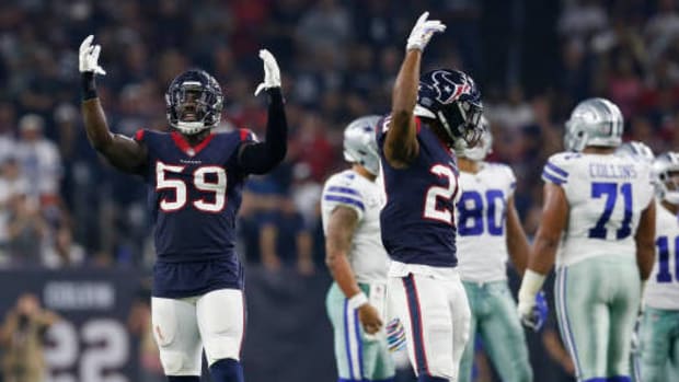 HOUSTON, TX - OCTOBER 07: Whitney Mercilus #59 of the Houston Texans and Justin Reid #20 signal for the crowd to make noise in the first half against the Dallas Cowboys at NRG Stadium on October 7, 2018 in Houston, Texas. (Photo by Tim Warner/Getty Images)