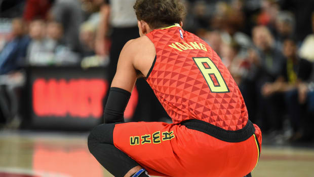 Atlanta Hawks guard Trae Young (11) wearing jersey number 8 to start the game to honor the memory of former NBA player Kobe Bryant holds the ball for 8 seconds at the start of the game against the Washington Wizards at State Farm Arena.
