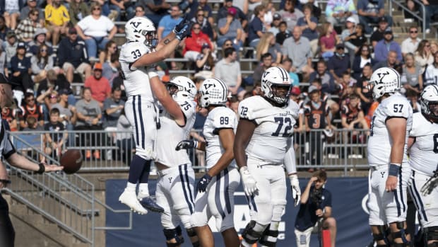 Oct 16, 2021; East Hartford, Connecticut, USA; Yale Bulldogs offensive lineman Camerson Warfield (75) lifts up Yale Bulldogs running back Zane Dudek (33) to celebrate him scoring a touchdown during the second half at Rentschler Field at Pratt &amp; Whitney Stadium. Mandatory Credit: Gregory Fisher-USA TODAY Sports