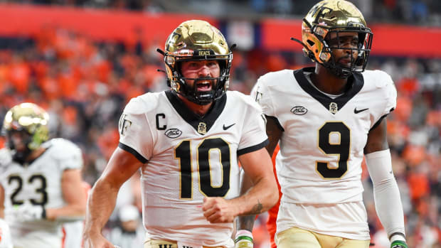 Oct 9, 2021; Syracuse, New York, USA; Wake Forest Demon Deacons quarterback Sam Hartman (10) reacts to his touchdown run with teammate wide receiver A.T. Perry (9) against the Syracuse Orange during the first half at the Carrier Dome. Mandatory Credit: Rich Barnes-USA TODAY Sports