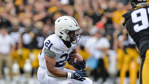 Oct 9, 2021; Iowa City, Iowa, USA; Penn State Nittany Lions running back Noah Cain (21) runs for a 2 yard touchdown during the first quarter against the Iowa Hawkeyes at Kinnick Stadium. Mandatory Credit: Jeffrey Becker-USA TODAY Sports