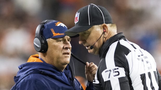 Denver Broncos head coach Vic Fangio talks with side judge Rob Vernatchi (75) during the fourth quarter against the Cleveland Browns at FirstEnergy Stadium.
