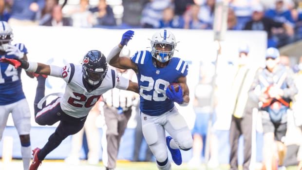 Oct 17, 2021; Indianapolis, Indiana, USA; Indianapolis Colts running back Jonathan Taylor (28) runs the ball while Houston Texans safety Justin Reid (20) defends in the second half at Lucas Oil Stadium.