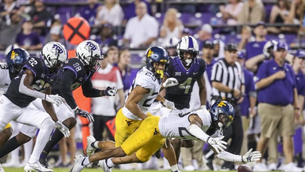 Oct 23, 2021; Fort Worth, Texas, USA; West Virginia Mountaineers defensive back Charles Woods (29) dives to recover a fumble during the fourth quarter against the TCU Horned Frogs at Amon G. Carter Stadium.