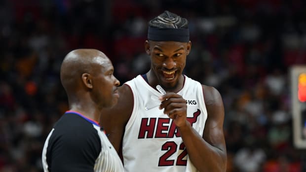 Oct 25, 2021; Miami, Florida, USA; Miami Heat forward Jimmy Butler (22) has a conversation with official Dedric Taylor (left) during the second half at FTX Arena. Mandatory Credit: Jim Rassol-USA TODAY Sports