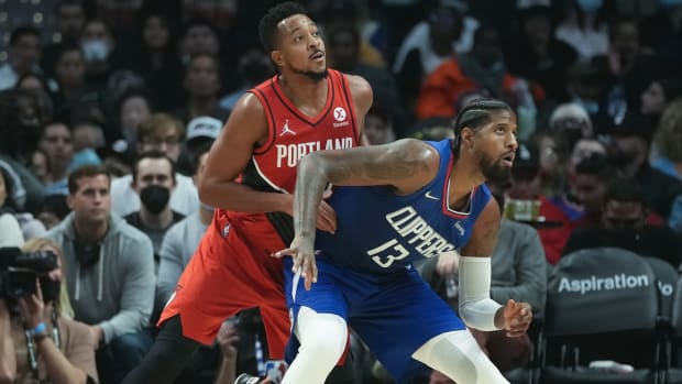Oct 25, 2021; Los Angeles, California, USA; LA Clippers guard Paul George (13) and Portland Trail Blazers guard CJ McCollum (3) jockey for position on the baseline during the second quarter at Staples Center. Mandatory Credit: Robert Hanashiro-USA TODAY Sports