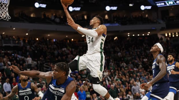 Oct 27, 2021; Milwaukee, Wisconsin, USA; Milwaukee Bucks forward Giannis Antetokounmpo (34) drives for the basket over Minnesota Timberwolves guard Anthony Edwards (1) during the fourth quarter at Fiserv Forum. Mandatory Credit: Jeff Hanisch-USA TODAY Sports