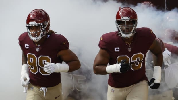 Washington Football Team defensive end Chase Young (99) and Washington Football Team defensive tackle Jonathan Allen (93) lead teammates onto the field prior to their game against the Kansas City Chiefs at FedExField.