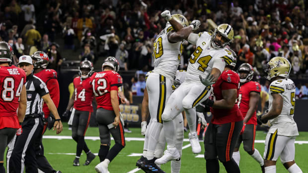 Oct 31, 2021; New Orleans, Louisiana, USA; New Orleans Saints defensive end Tanoh Kpassagnon (90) celebrate with defensive end Cameron Jordan (94) after sacking Tampa Bay Buccaneers quarterback Tom Brady (12) during the second half at Caesars Superdome. Mandatory Credit: Stephen Lew-USA TODAY Sports