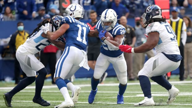 Indianapolis Colts running back Jonathan Taylor (28) rushes the ball past Tennessee Titans defensive end Larrell Murchison (91) for first and goal Sunday, Oct. 31, 2021, during a game against the Tennessee Titans at Lucas Oil Stadium in Indianapolis.