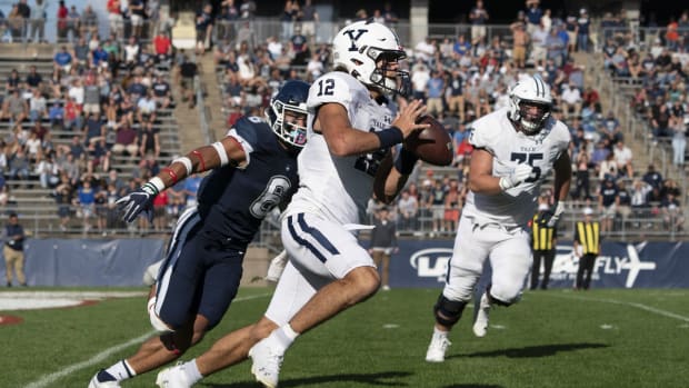 Oct 16, 2021; East Hartford, Connecticut, USA; Yale Bulldogs quarterback Nolan Grooms (12) runs with the ball with Connecticut Huskies linebacker Ian Swenson (6) in pursuit during the second half at Rentschler Field at Pratt &amp; Whitney Stadium. Mandatory Credit: Gregory Fisher-USA TODAY Sports