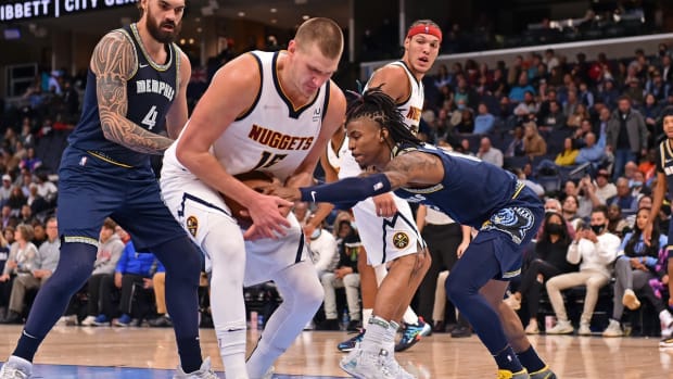 Nov 3, 2021; Memphis, Tennessee, USA; Denver Nuggets center Nikola Jokic (15) and Memphis Grizzlies guard Ja Morant (12) fight for the ball during the second half at FedExForum. Mandatory Credit: Justin Ford-USA TODAY Sports