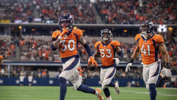 Denver Broncos safety Caden Sterns (30) motions to the Dallas Cowboys fans after he intercepts a pass during the second half at AT&T Stadium.