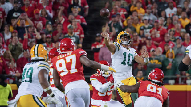 Green Bay Packers quarterback Jordan Love (10) jumps and throws a pass against the Kansas City Chiefs during the second half at GEHA Field at Arrowhead Stadium.