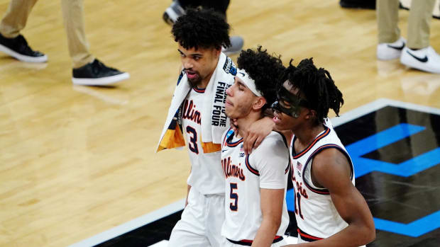 Mar 21, 2021; Indianapolis, Indiana, USA; Illinois Fighting Illini guard Jacob Grandison (3) and guard Andre Curbelo (5) and guard Ayo Dosunmu (11) react as they walk off the court after their loss to the Loyola Ramblers in the second round of the 2021 NCAA Tournament at Bankers Life Fieldhouse. The Loyola Ramblers won 71-58. Mandatory Credit: Kirby Lee-USA TODAY Sports
