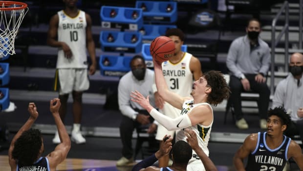 Mar 27, 2021; Indianapolis, IN, USA; Baylor Bears guard Matthew Mayer (top) shoots the ball against Villanova Wildcats forward Jeremiah Robinson-Earl (24) and forward Eric Dixon (43) and forward Jermaine Samuels (23) in the second half during the Sweet 16 of the 2021 NCAA Tournament at Hinkle Fieldhouse. Mandatory Credit: Doug McSchooler-USA TODAY Sports
