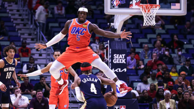 Nov 10, 2021; New Orleans, Louisiana, USA; 
Oklahoma City Thunder forward Luguentz Dort (5) tries to block. Shot by New Orleans Pelicans guard Devonte' Graham (4) during the first half at Smoothie King Center. Mandatory Credit: Stephen Lew-USA TODAY Sports