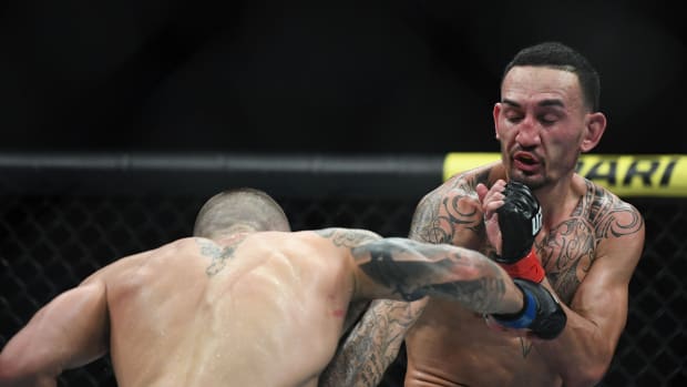 Dec 14, 2019; Las Vegas, NV, USA; Max Holloway (red gloves) fights Alexander Volkanovski (blue gloves) during UFC 245 at T-Mobile Arena.