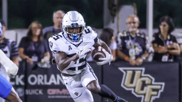 Oct 22, 2021; Orlando, Florida, USA; UCF Knights running back Johnny Richardson (25) carries the ball against the Memphis Tigers during the second half at Bounce House. Mandatory Credit: Mike Watters-USA TODAY Sports