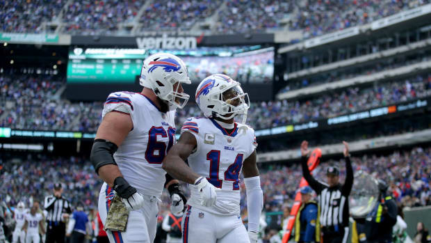 Bills wide receiver Stefon Diggs (14) celebrates a touchdown against the New York Jets with center Mitch Morse (60) during the second quarter at MetLife Stadium.