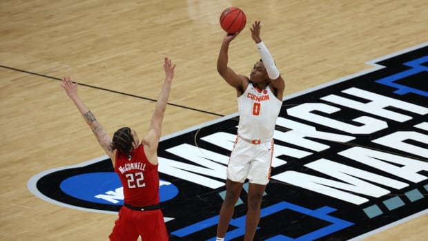 Mar 19, 2021; Indianapolis, Indiana, USA; Clemson Tigers guard Clyde Trapp (0) shoots the ball over Rutgers Scarlet Knights guard Caleb McConnell (22) during the second half in the first round of the 2021 NCAA Tournament at Bankers Life Fieldhouse. Mandatory Credit: Trevor Ruszkowski-USA TODAY Sports