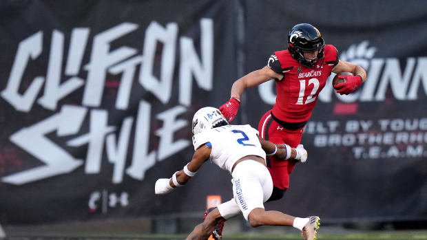 Cincinnati Bearcats wide receiver Alec Pierce (12) turns downfield after completing a catch as Tulsa Golden Hurricane cornerback Travon Fuller (2) defends in the third quarter during an NCAA football game, Saturday, Nov. 6, 2021, at Nippert Stadium in Cincinnati. The Cincinnati Bearcats won, 28-20. Tulsa Golden Hurricane At Cincinnati Bearcats Nov 6