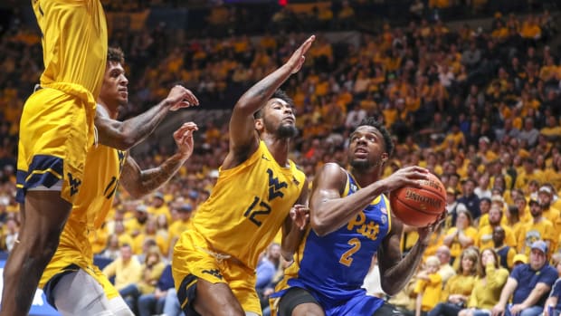 Nov 12, 2021; Morgantown, West Virginia, USA; Pittsburgh Panthers guard Femi Odukale (2) drives baseline against West Virginia Mountaineers guard Taz Sherman (12) during the first half at WVU Coliseum. Mandatory Credit: Ben Queen-USA TODAY Sports