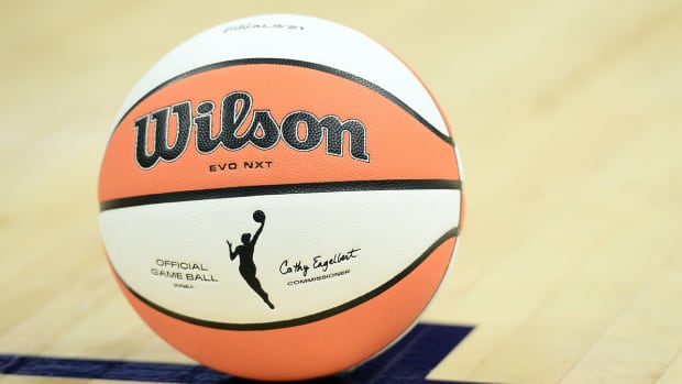 A WNBA basketball sits on the court.