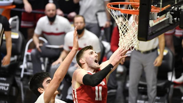 Mar 2, 2021; West Lafayette, Indiana, USA; Wisconsin Badgers forward Micah Potter (11) shoots the ball against Purdue Boilermakers center Zach Edey (15) during the second half of the game at Mackey Arena. Mandatory Credit: Marc Lebryk-USA TODAY Sports
