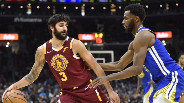 Nov 18, 2021; Cleveland, Ohio, USA; Golden State Warriors forward Andrew Wiggins (22) defends Cleveland Cavaliers guard Ricky Rubio (3) in the third quarter at Rocket Mortgage FieldHouse. Mandatory Credit: David Richard-USA TODAY Sports