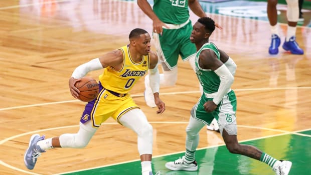 Nov 19, 2021; Boston, Massachusetts, USA; Los Angeles Lakers guard Russell Westbrook (0) drives to the basket defended by Boston Celtics guard Dennis Schroder (71) during the first half at TD Garden. Mandatory Credit: Paul Rutherford-USA TODAY Sports