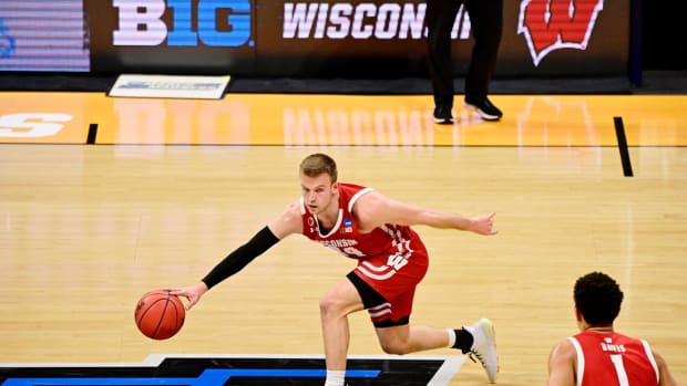Mar 21, 2021; Indianapolis, Indiana, USA; Wisconsin Badgers guard Brad Davison (34) dribbles against the Baylor Bears during the second half in the second round of the 2021 NCAA Tournament at Hinkle Fieldhouse. The Baylor Bears won 76-63. Mandatory Credit: Marc Lebryk-USA TODAY Sports