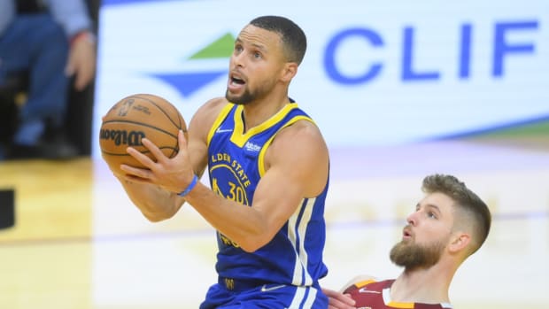 Nov 18, 2021; Cleveland, Ohio, USA; Golden State Warriors guard Stephen Curry (30) drives to the basket beside Cleveland Cavaliers forward Dean Wade (32) in the fourth quarter at Rocket Mortgage FieldHouse. Mandatory Credit: David Richard-USA TODAY Sports