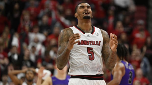 Nov 12, 2021; Louisville, Kentucky, USA; Louisville Cardinals forward Malik Williams (5) reacts after committing a foul against the Furman Paladins during the second half at KFC Yum! Center. Furman defeated Louisville 80-72. Mandatory Credit: Jamie Rhodes-USA TODAY Sports