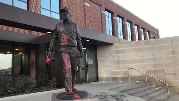 Bo Schembechler statue at Michigan is vandalized before Ohio State game, with message about victims of Robert Anderson.