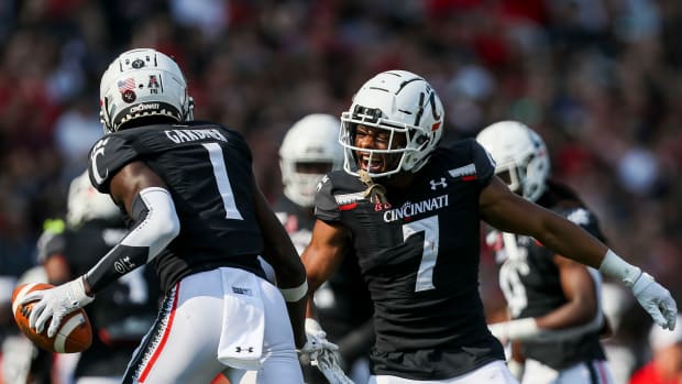 Sep 11, 2021; Cincinnati, Ohio, USA; Cincinnati Bearcats cornerback Coby Bryant (7) reacts with cornerback Ahmad Gardner (1) after an interception against the Murray State Racers in the first half at Nippert Stadium. Mandatory Credit: Katie Stratman-USA TODAY Sports