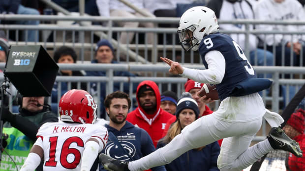 Nov 20, 2021; University Park, Pennsylvania, USA; Penn State Nittany Lions quarterback Christian Veilleux (9) leaps into the air to avoid a tackle during the fourth quarter against the Rutgers Scarlet Knights at Beaver Stadium. Penn State defeated Rutgers 28-0. Mandatory Credit: Matthew OHaren-USA TODAY Sports