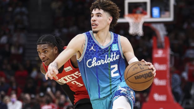 Nov 27, 2021; Houston, Texas, USA; Charlotte Hornets guard LaMelo Ball (2) drives with the ball as Houston Rockets guard Kevin Porter Jr. (3) defends during overtime at Toyota Center. Mandatory Credit: Troy Taormina-USA TODAY Sports