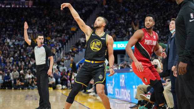 Nov 26, 2021; San Francisco, California, USA; Golden State Warriors guard Stephen Curry (30) shoots a 3-pointer as Portland Trail Blazers guard CJ McCollum (3) watches during the fourth quarter at Chase Center. Mandatory Credit: Darren Yamashita-USA TODAY Sports