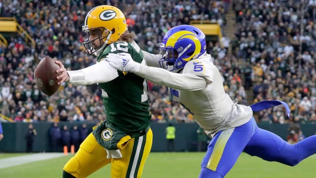Aaron Rodgers reaches for a touchdown as Jalen Ramsey tries to tackle him