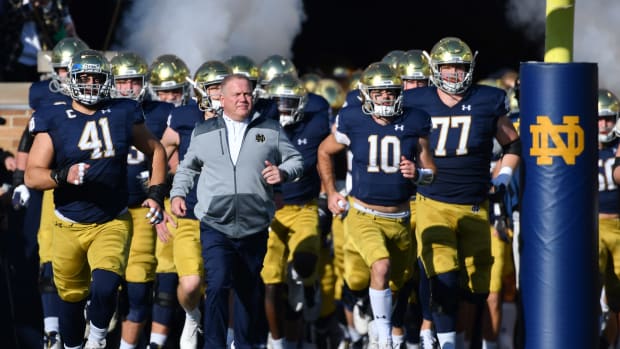 Nov 6, 2021; South Bend, Indiana, USA; Notre Dame Fighting Irish head coach Brian Kelly leads players onto the field before the game against the Navy Midshipmen at Notre Dame Stadium. Mandatory Credit: Matt Cashore-USA TODAY Sports