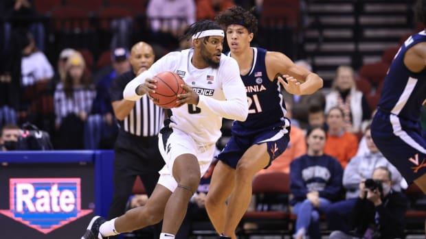 Nov 23, 2021; Newark, NJ, USA; Providence Friars center Nate Watson (0) dribbles as Virginia Cavaliers forward Kadin Shedrick (21) defends during the first half at Prudential Center. Mandatory Credit: Vincent Carchietta-USA TODAY Sports